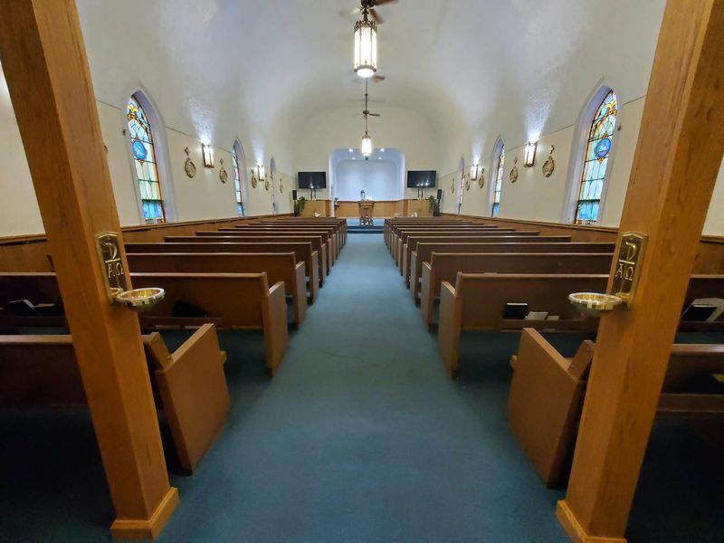 Wide view of the sanctuary with stained-glass windows